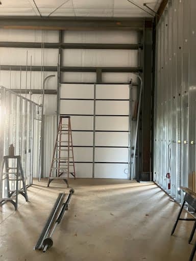 Interior staging of commercial sectional door tracks and torsion hardware