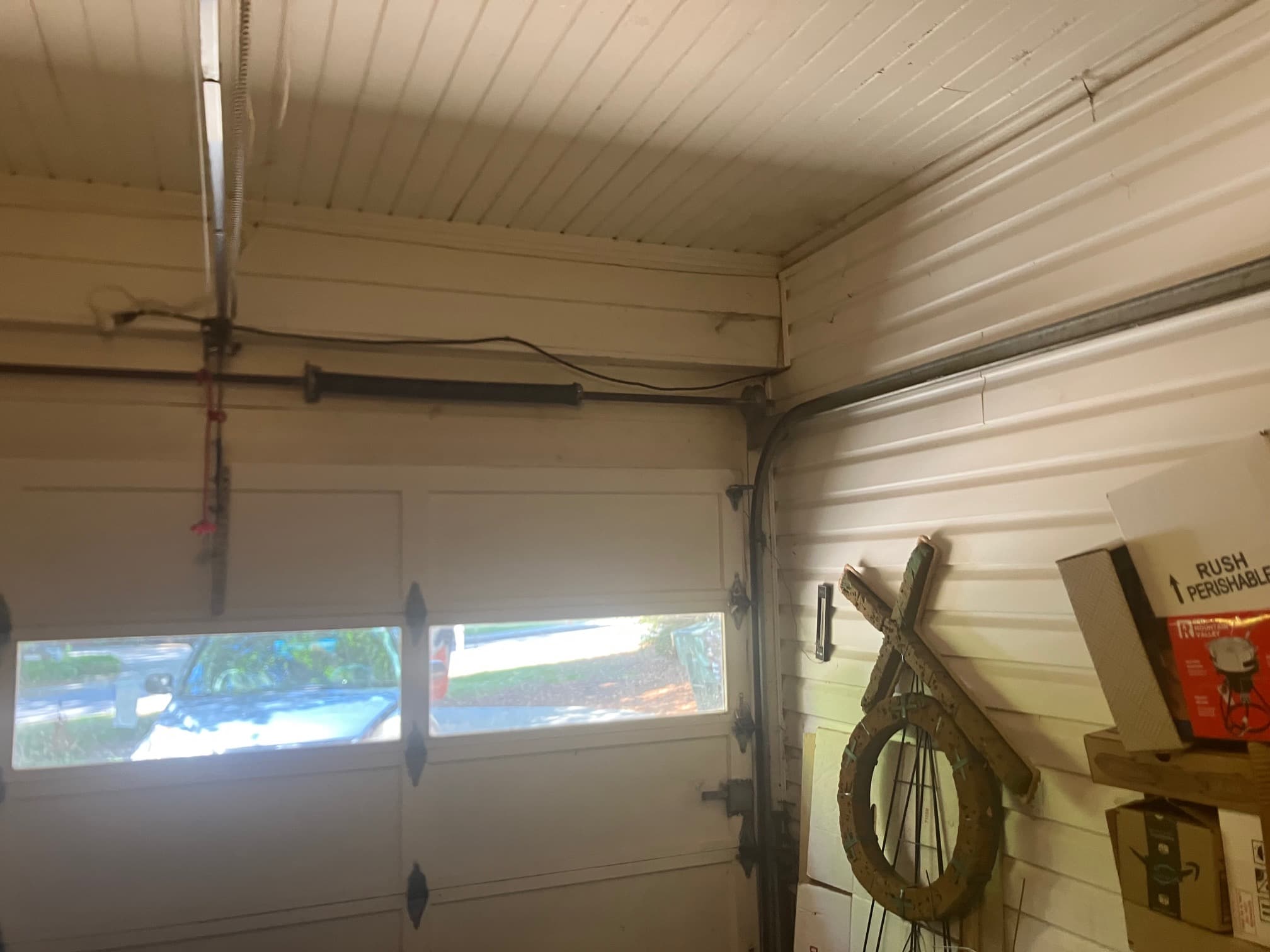Broken torsion spring on residential garage door header
