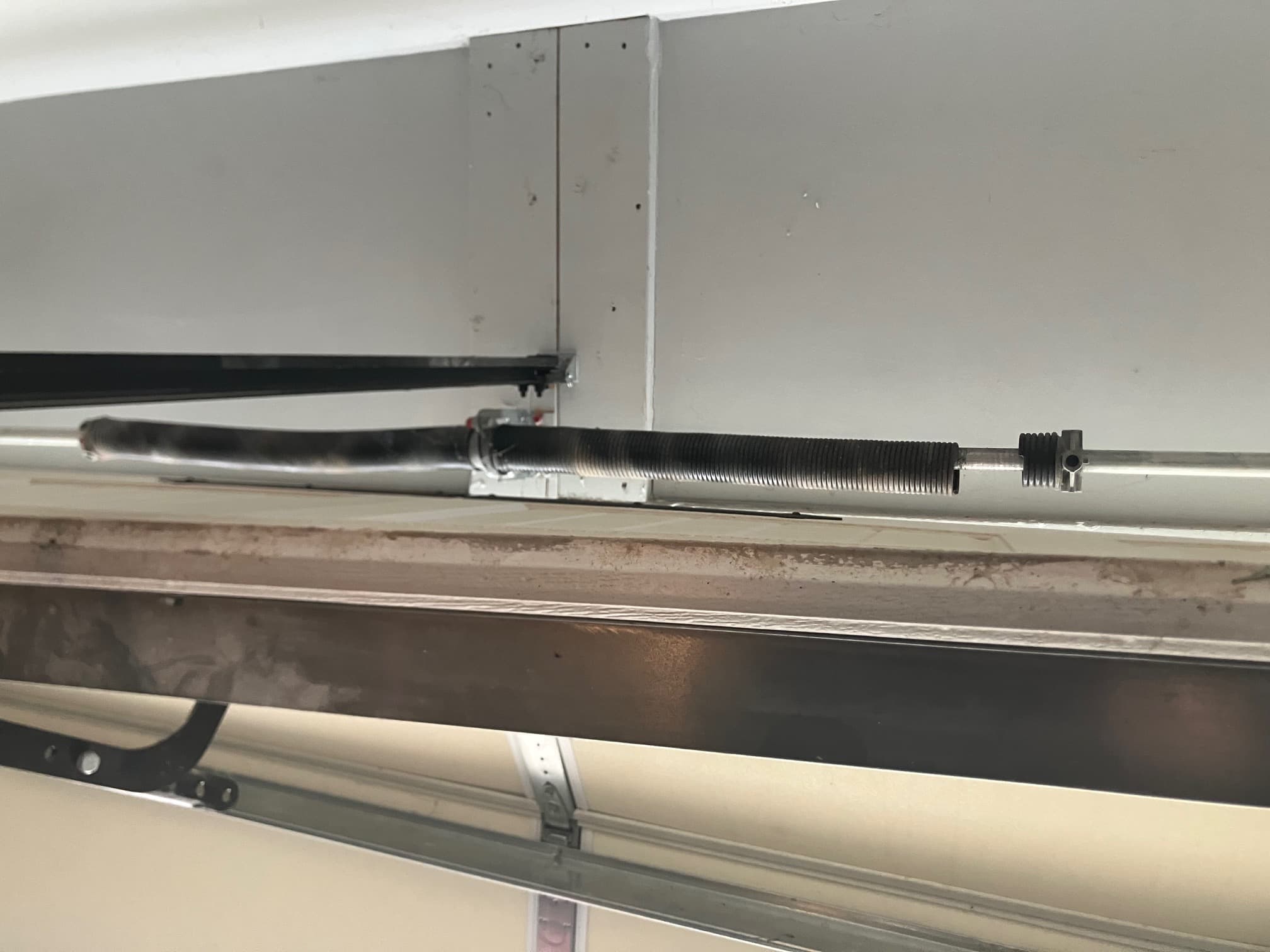 Broken torsion spring snapped near winding cone